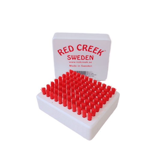 A product picture of the Red Creek Red Nylon Mini Hand Brush