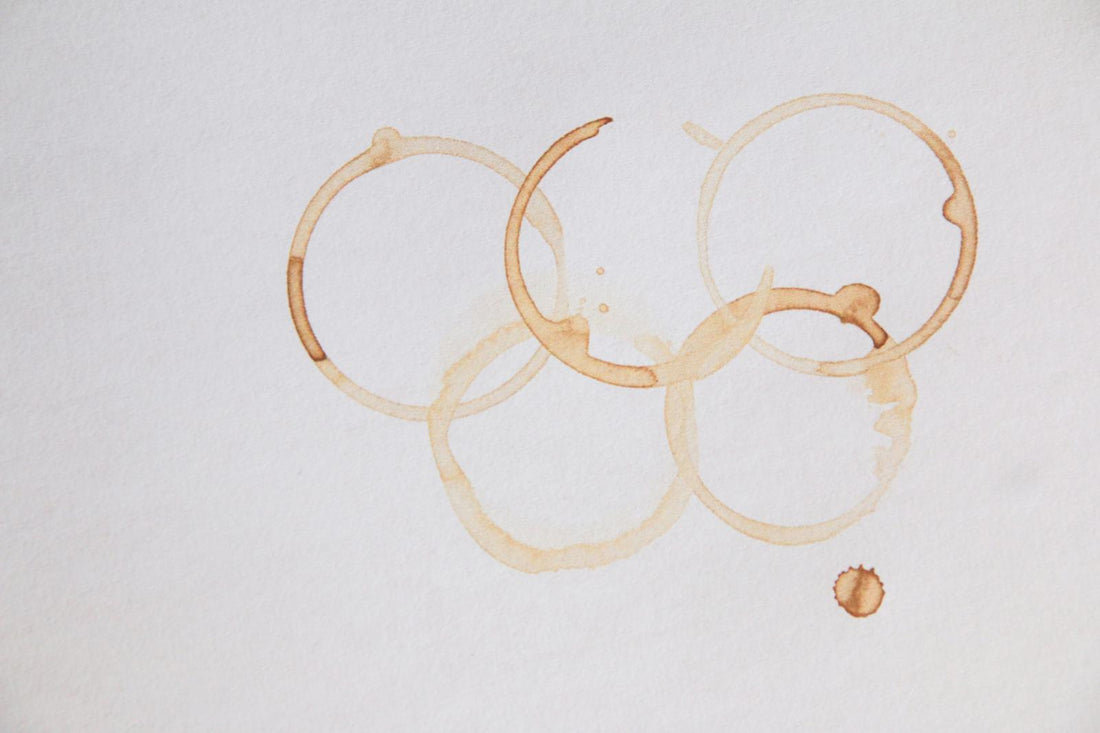 Olympic rings formed by coffee stains on paper