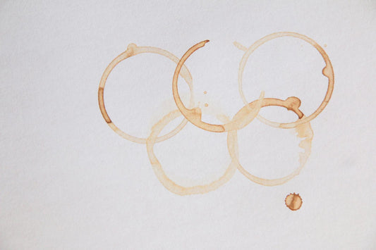 Olympic rings formed by coffee stains on paper