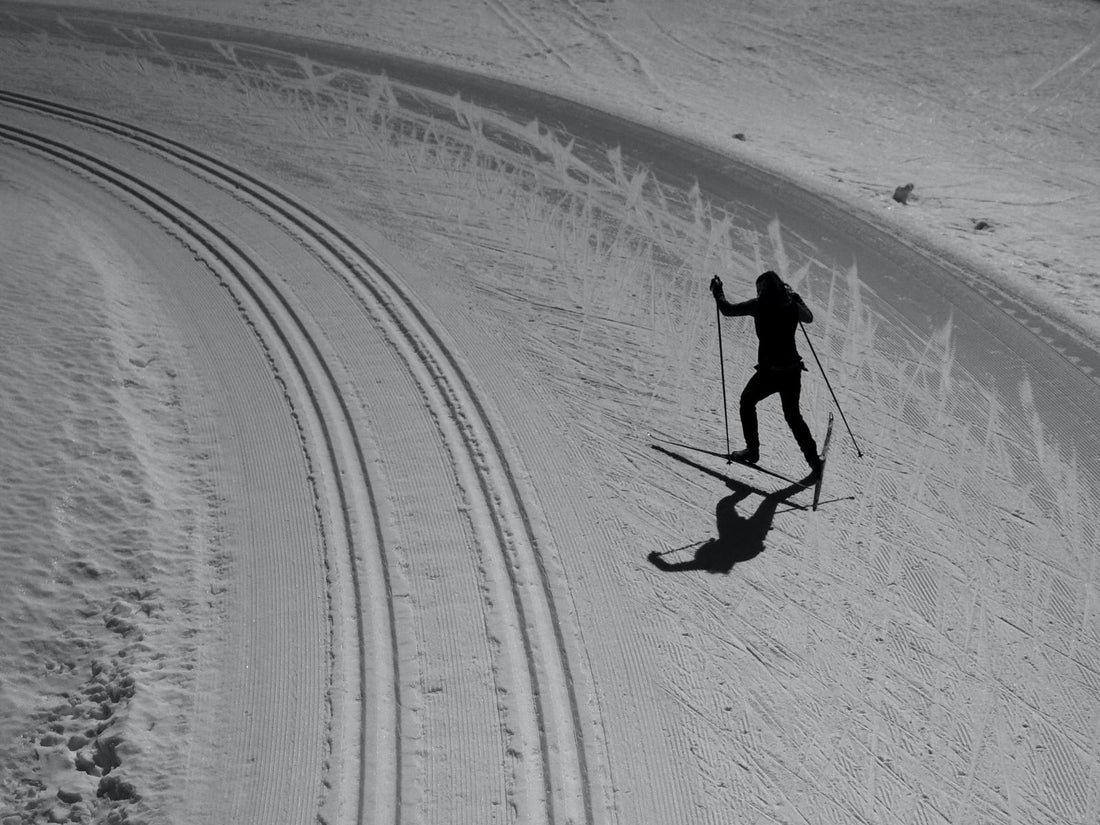 Coach working with young cross-country skiers