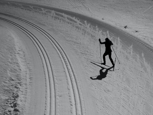 Coach working with young cross-country skiers